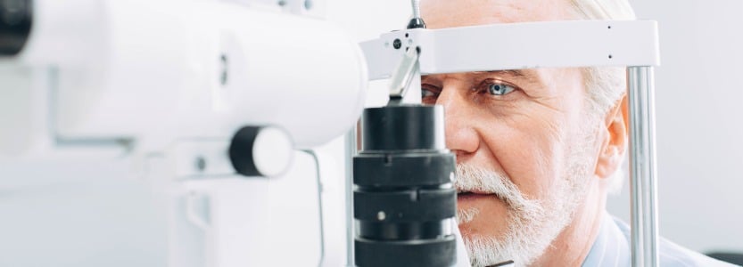senior man getting eye exam at clinic closeup picture id1055656524
